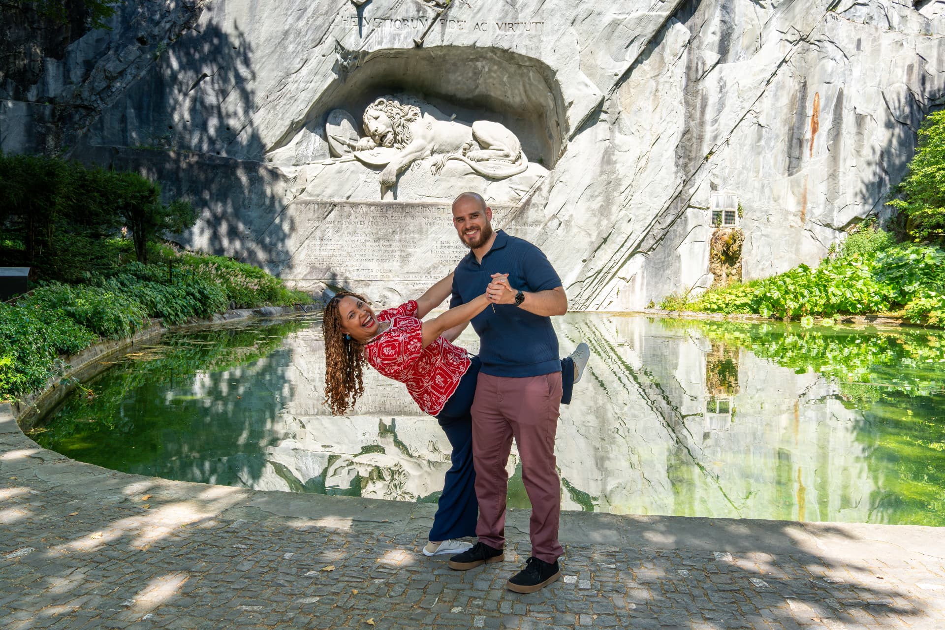 Couple dancing by the pond at the Lion Monument