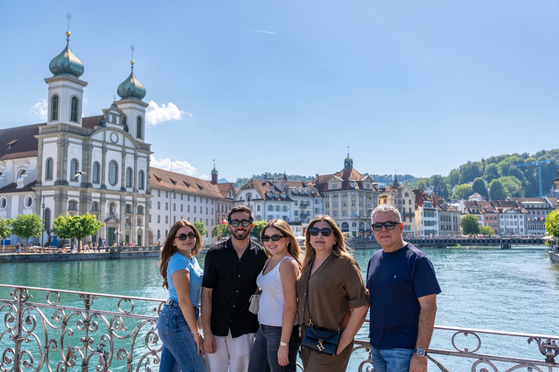 Family by the Reuss river with the Jesuit Church behind