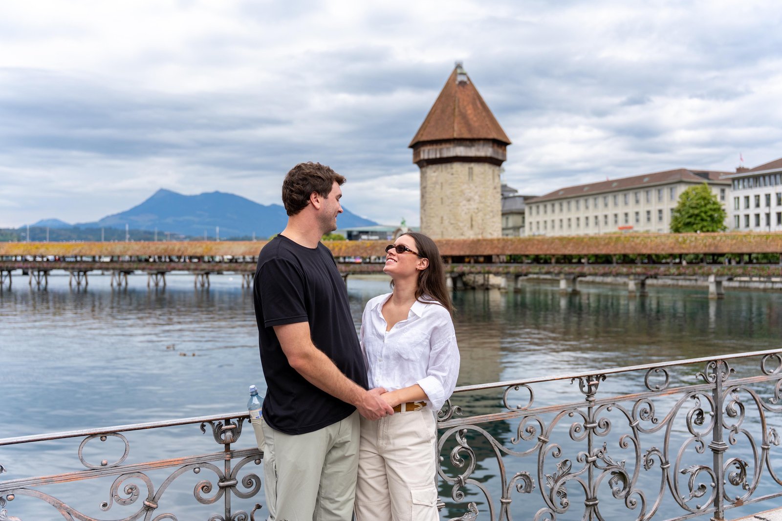 Couple by the lakefront with the water tower behind